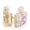 Perfume bottle with crystals and flowers - keychainKeyrings