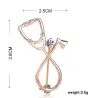 Stethoscope shaped brooch with crystal
