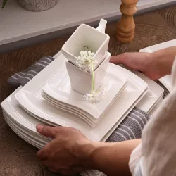 Elegant tableware - white porcelain dinner set - cups - saucers - platesCutlery