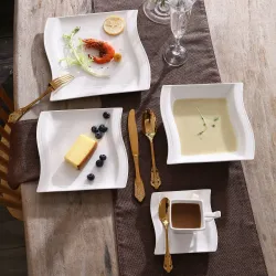 Elegant tableware - white porcelain dinner set - cups - saucers - platesCutlery