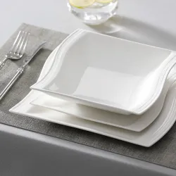 Elegant tableware - white porcelain dinner set - cups - saucers - platesCutlery