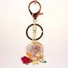 Golden crystal skull with rose - keychainKeyrings